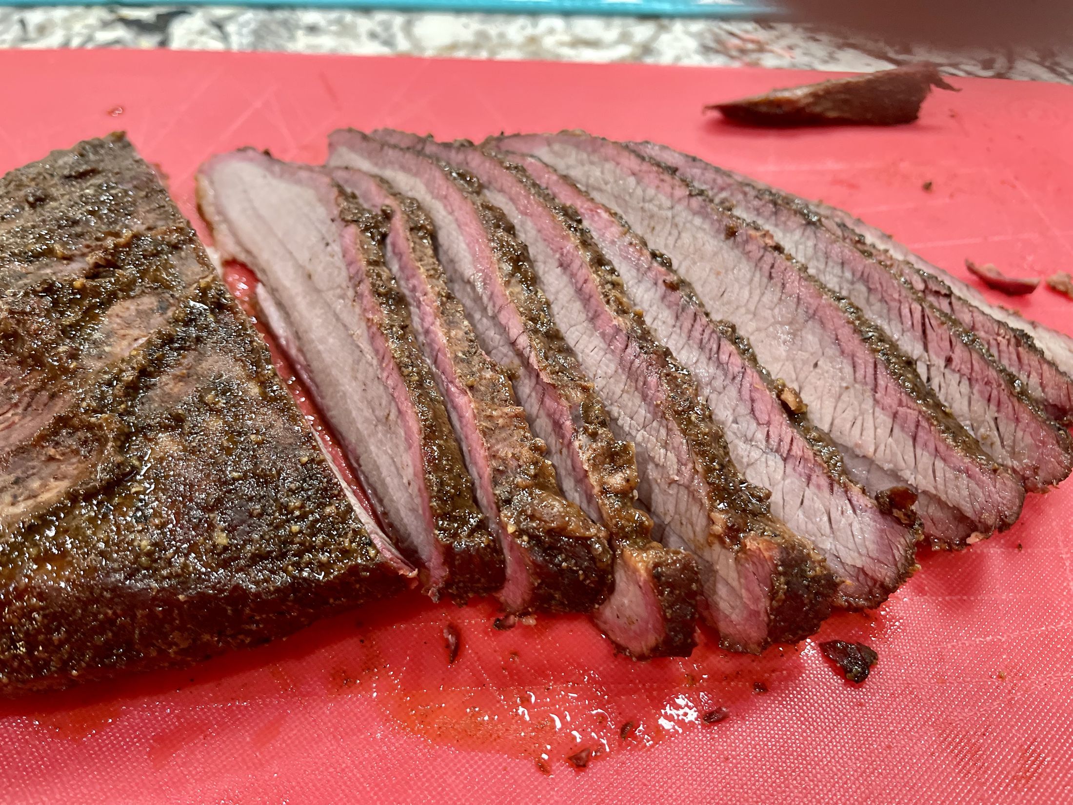 Sliced smoked brisket with a deep smoke ring